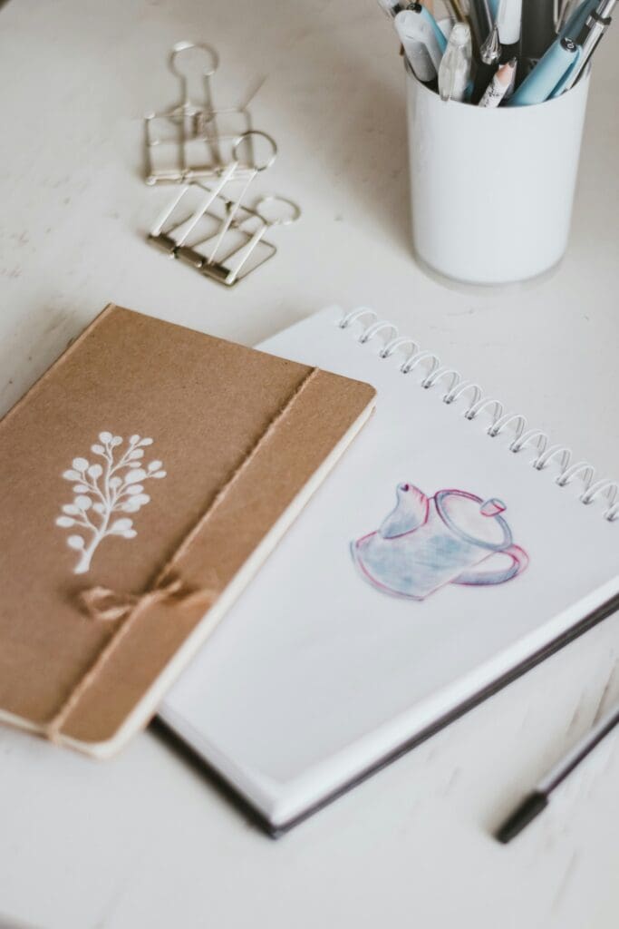 Handmade Journal and hand-made spiral bound journal on table